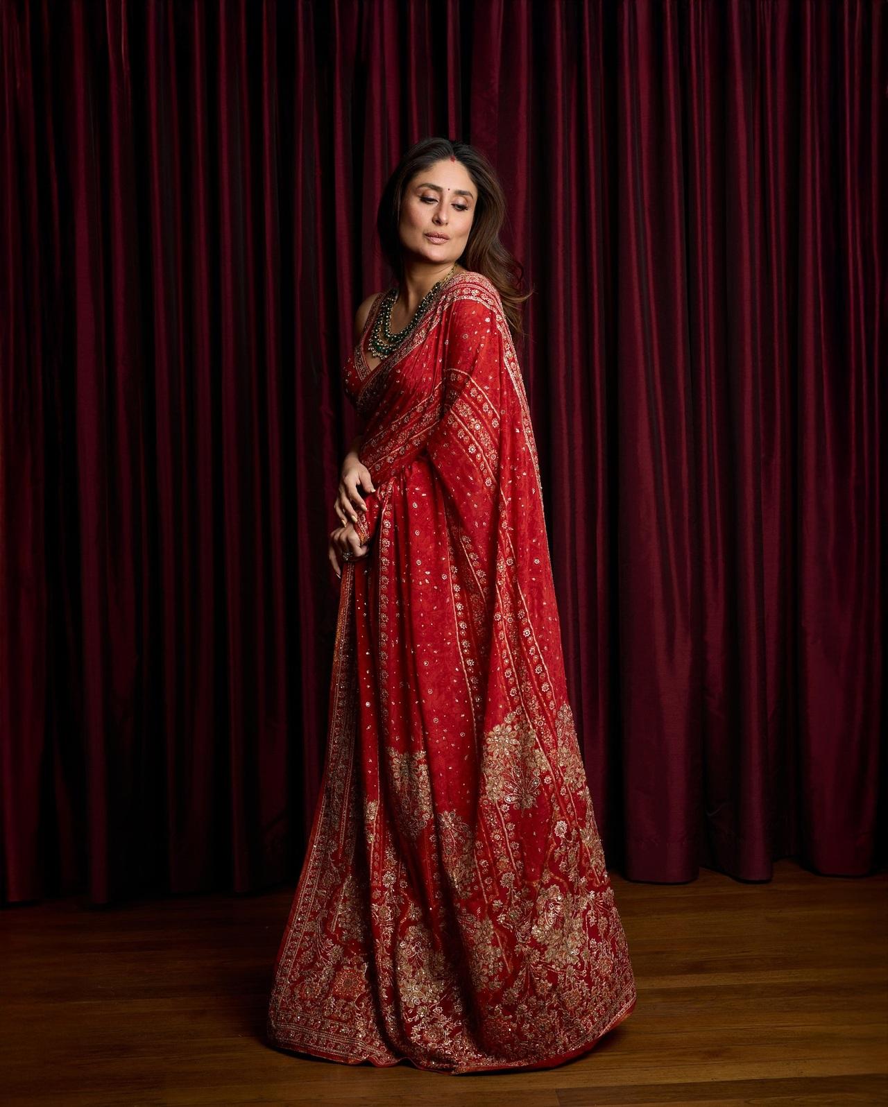 Kareena Kapoor Khan looks stunning in this elegant red saree — a dreamy pick for brides-to-be this wedding season. The saree features delicate golden embroidery and intricate detailing. She pairs it with a simple blouse and a statement emerald necklace.